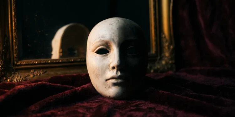White theatrical mask in dramatic lighting — psychopath test personality assessment