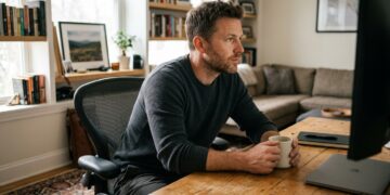Man working focused at desk representing intrinsic vs extrinsic motivation